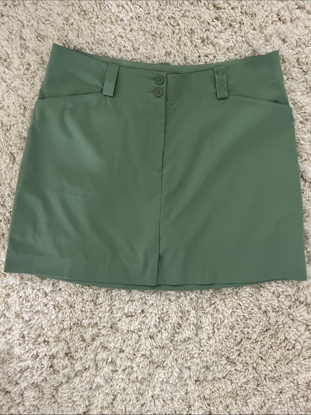 Nike Olive Green Golf Skort with Front Button Detail with holder for tees.